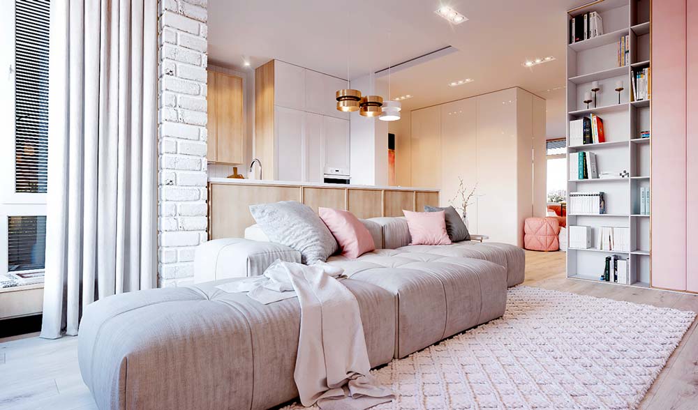 Salon contemporain clair avec des coussins, un pouf et une armoire vieux rose