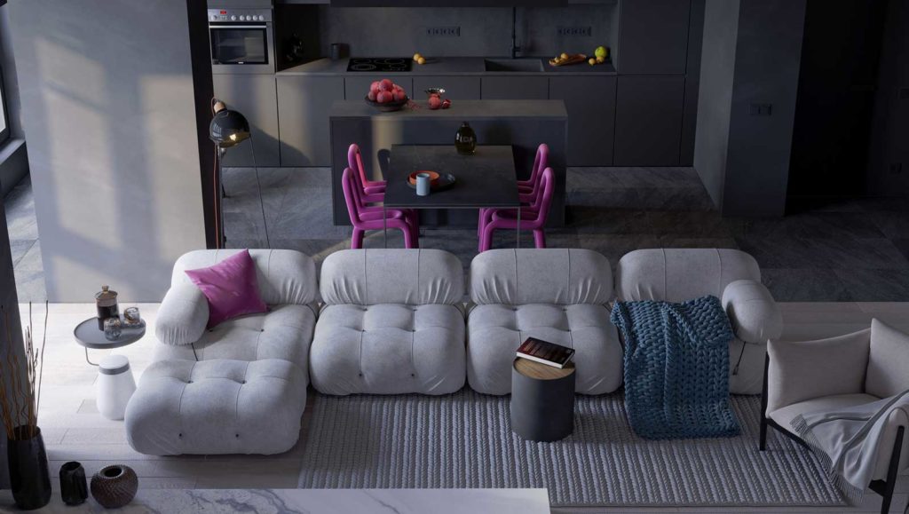 Les canapés modulables aux formes arrondies s'intègrent à un coin salon cuisine avec des meubles sombres, une table et des chaises en tube rose