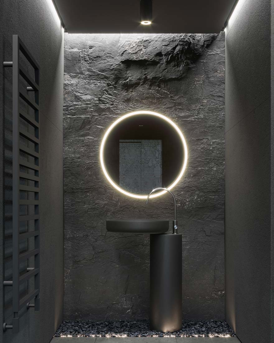 Une salle de bain grise avec un mur en pierre, un chauffage vertical et un petit miroir rond éclairé d'un néon circulaire au-dessus d'un lavabo gris