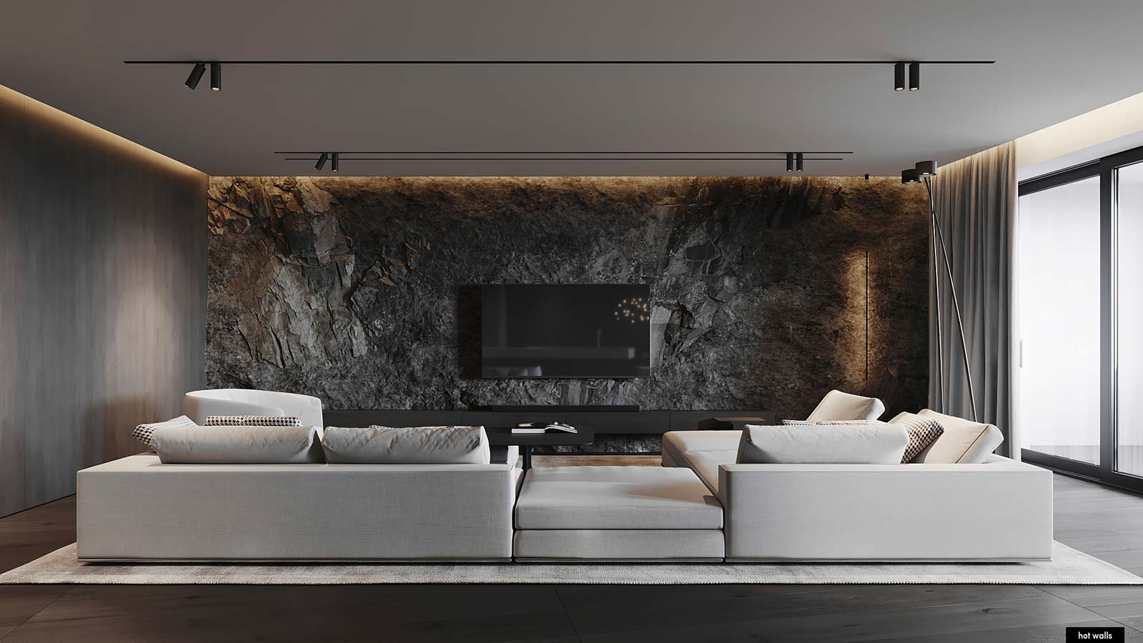 Un grand salon chaleureux avec des murs en pierre et bois et un grand canapé blanc au centre