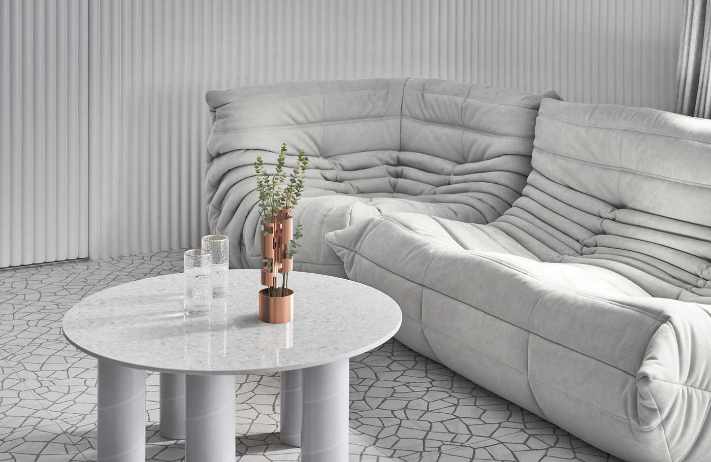 Une table basse avec des pieds en tube et de la petite déco rose gold dans un salon total white