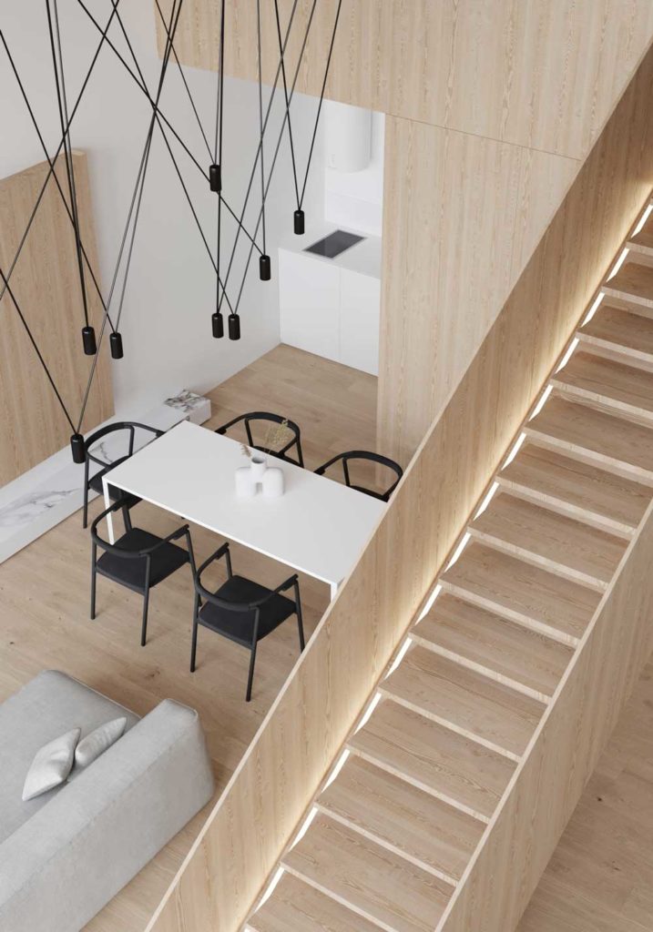 Une salle à manger design avec des suspensions lumineuses noires et un grand escalier rétroéclairé en bois blond