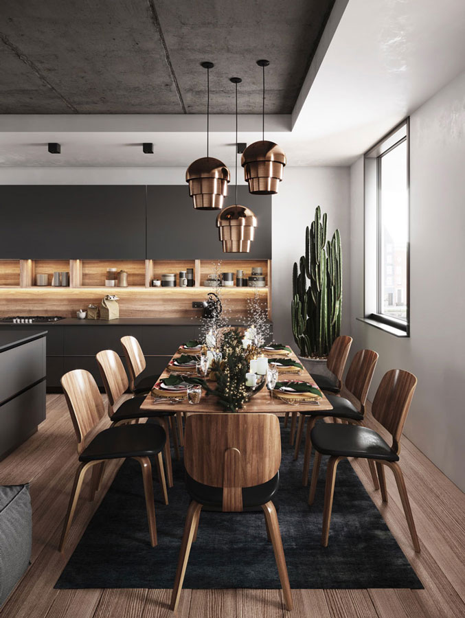 Une cuisine chaleureuse avec des tables et des chaises et du mobilier de cuisine en bois, un parquet un chêne foncé, un lustre en cuivre brillant orne la pièce