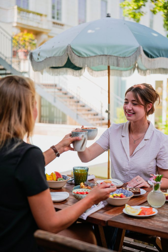 Deux amies qui profite en terrasse d'un hôtel, savourant l'escale du midi.